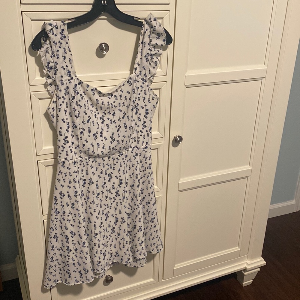 Black flowers  on white dress. Fluttering straps, backless, and tied with a bow